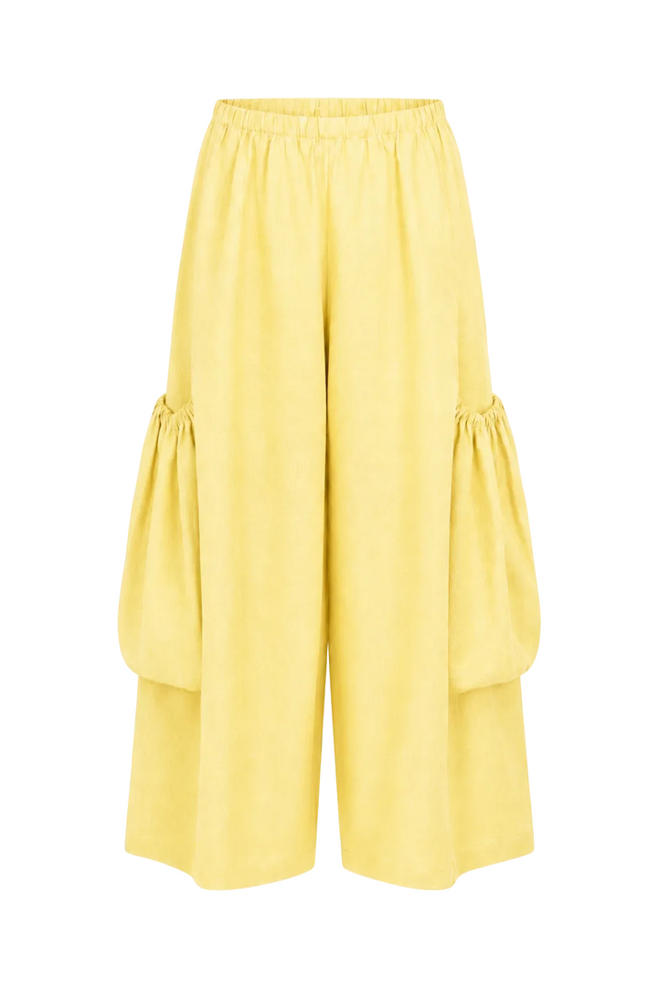 Yellow wide-leg cropped pants with gathered balloon details on the outer sides, shown against a plain white background.