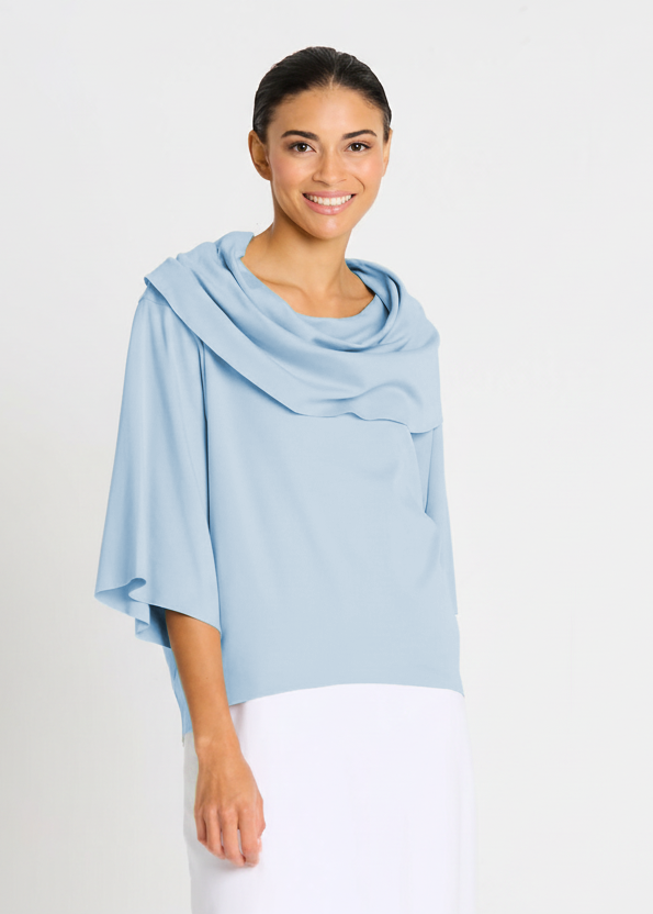 Woman wearing a light blue pima cotton jackie o top tee against a white background