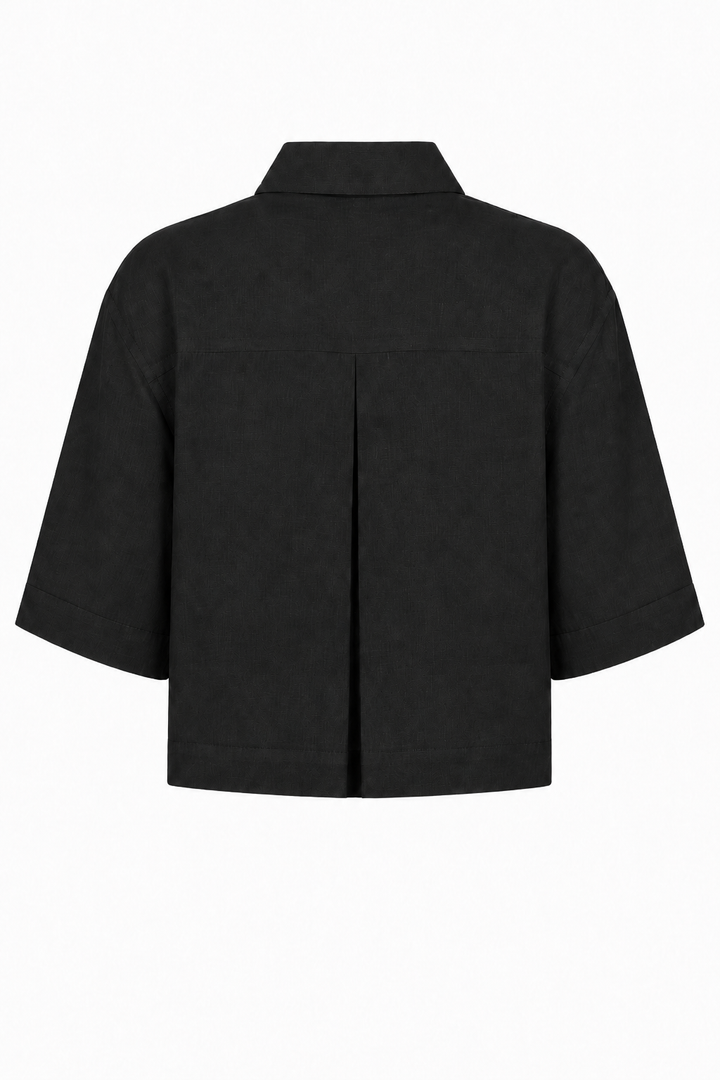 A black short-sleeve cropped jacket with a pointed collar and a central front seam, shown from the back on a plain white background.