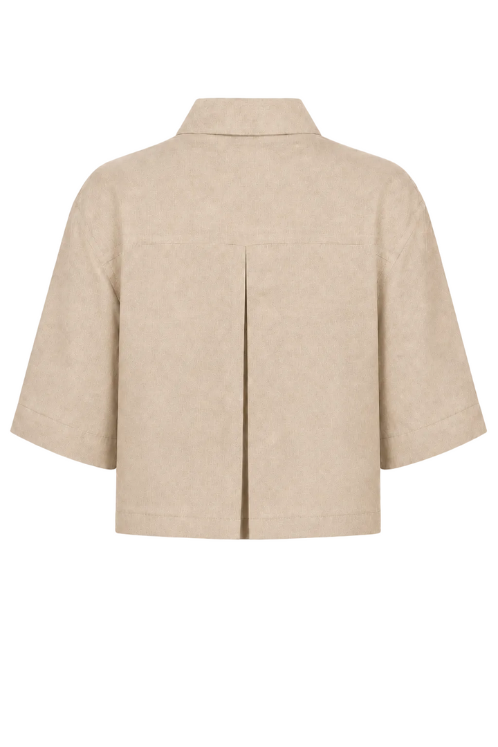 A 100% linen beige cropped jacket with short sleeves, a pointed collar, and a central front pleat, shown from the back on a plain white background.