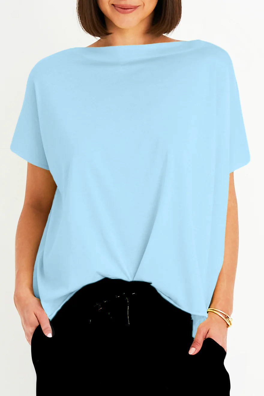 Woman wearing a light blue oversized t-shirt against a white background