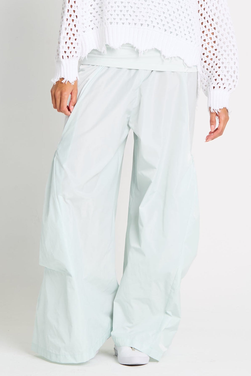 Mint wide-leg pants worn by a person on a white background