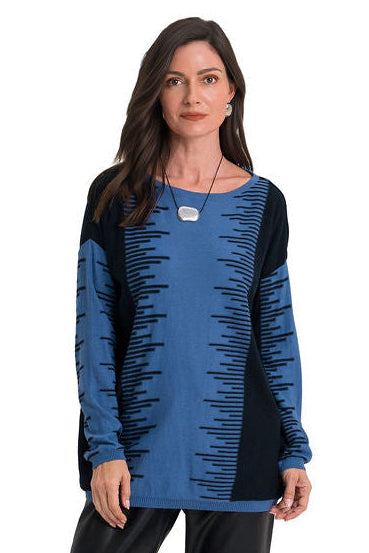 A woman modeling a long-sleeve pima cotton knit top with a color-blocked design featuring a medium blue body with black horizontal dash patterns, and solid black sleeves and side panels.