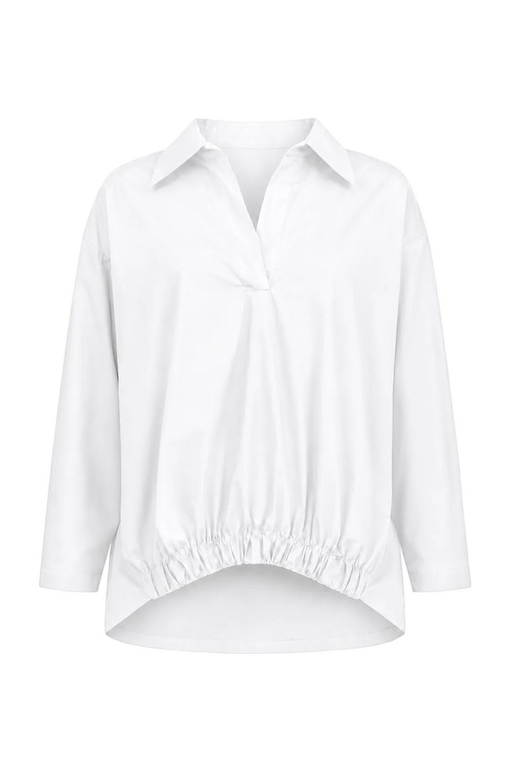 A 100% cotton white long-sleeve button-up blouse with a pointed collar, gathered front detail, and an elasticized hem, shown on a plain white background.