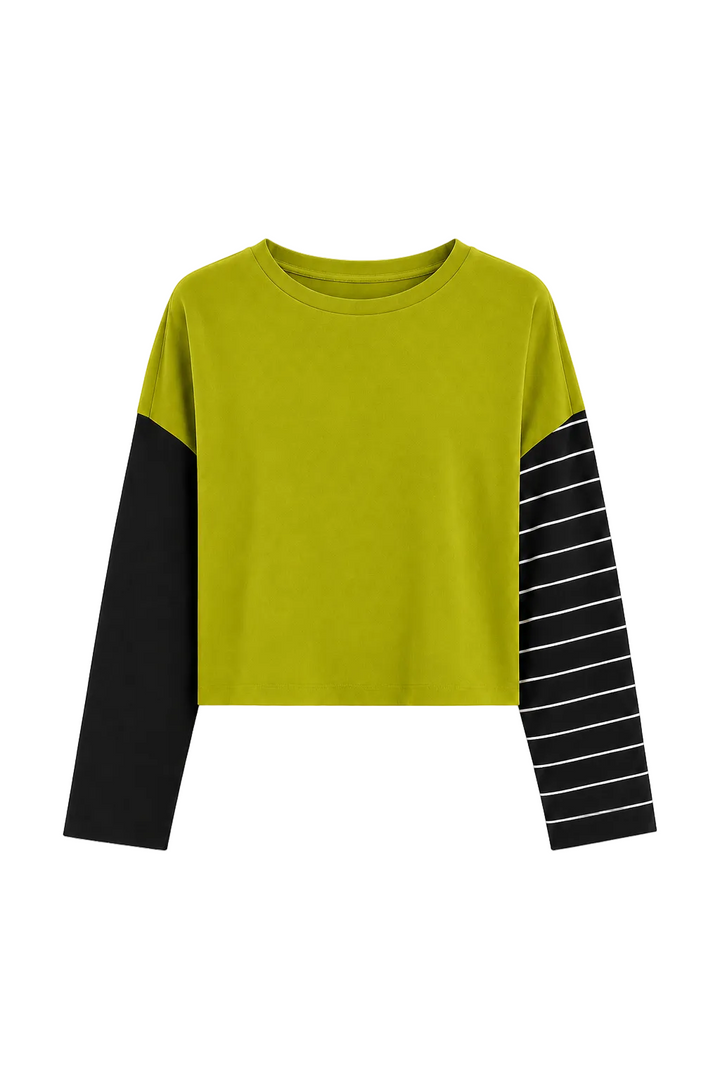 A cropped pima cotton long-sleeve top in bright yellow-green with one solid black sleeve and one black sleeve featuring thin white horizontal stripes, shown on a plain light gray background.